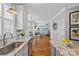 Bright, renovated kitchen with granite counters, stainless appliances, and an open view to the breakfast and living area at 9427 Gilpatrick Ln # 5, Huntersville, NC 28078