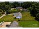 Aerial view of a white home with a backyard, green lawn, and a pool in the neighboring property at 958 Hillard Ln, Lincolnton, NC 28092
