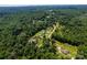 Aerial view of a neighborhood with a single street with homes, green trees, and a blue sky at 958 Hillard Ln, Lincolnton, NC 28092