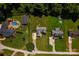 An aerial view displaying multiple properties with green lawns, pools, and surrounded by trees at 958 Hillard Ln, Lincolnton, NC 28092