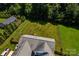 Aerial view of the property showcasing the home, large backyard, and surrounding trees at 958 Hillard Ln, Lincolnton, NC 28092