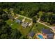Aerial view showcases the property and the neighborhood surrounded by lush green trees at 958 Hillard Ln, Lincolnton, NC 28092