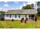 Charming home exterior with a wooden deck, grassy yard, and white siding at 958 Hillard Ln, Lincolnton, NC 28092
