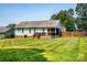 Well-maintained backyard showcasing a wooden deck and fenced yard at 958 Hillard Ln, Lincolnton, NC 28092