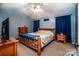 A charming bedroom features blue walls, natural wood furniture, and a ceiling fan at 958 Hillard Ln, Lincolnton, NC 28092