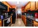 Functional kitchen with wooden cabinets, black appliances, and black tile backsplash at 958 Hillard Ln, Lincolnton, NC 28092