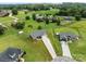 Aerial view of the property showcases a spacious lawn, wooden fence, and a well-maintained home in a quiet neighborhood at 100 Royal Ave, Albemarle, NC 28001