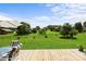 Well-maintained backyard with green grass, a wooden fence, and an inviting deck with outdoor furniture at 100 Royal Ave, Albemarle, NC 28001