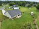 Aerial view of backyard featuring green lawn, wooden fence, and a deck with outdoor dining furniture at 100 Royal Ave, Albemarle, NC 28001