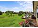 Scenic backyard with a spacious lawn, wooden fencing, and a deck with an umbrella, providing a peaceful retreat at 100 Royal Ave, Albemarle, NC 28001