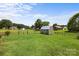 Large backyard with a well-kept lawn, a storage shed, and a wooden fence, offering ample space for recreation at 100 Royal Ave, Albemarle, NC 28001