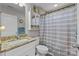 Bathroom featuring a granite countertop, shower with curtain and a mirror at 100 Royal Ave, Albemarle, NC 28001