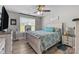 Cozy bedroom features a bright window, wood-look flooring, and a neutral color palette at 100 Royal Ave, Albemarle, NC 28001