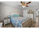 Comfortable bedroom featuring a ceiling fan, hardwood floors, and ample natural light at 100 Royal Ave, Albemarle, NC 28001