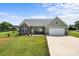 Beautiful single-Gathering home featuring a lush lawn, a driveway to the two car garage, and a welcoming facade at 100 Royal Ave, Albemarle, NC 28001