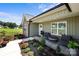 Inviting front porch featuring cozy seating and a beautifully landscaped garden, perfect for relaxing outdoors at 100 Royal Ave, Albemarle, NC 28001