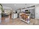 Bright open-concept kitchen flowing into the living area and featuring modern stainless steel appliances and bar seating at 100 Royal Ave, Albemarle, NC 28001