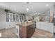 Spacious kitchen features a large island, granite countertops, and custom white display cabinets at 100 Royal Ave, Albemarle, NC 28001