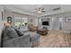 Bright living room with a ceiling fan, wood flooring, and comfortable seating near a window with great natural light at 100 Royal Ave, Albemarle, NC 28001