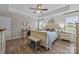 This light and airy main bedroom features wood-look floors, a ceiling fan, and neutral decor at 100 Royal Ave, Albemarle, NC 28001