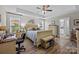 This main bedroom offers natural light, wood-look flooring, and an ensuite bathroom at 100 Royal Ave, Albemarle, NC 28001