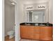 Bathroom with double sinks, wood cabinets, granite countertops, and neutral wall color at 1112 Wagner Ave # 335, Fort Mill, SC 29715