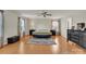 Well-lit bedroom features wood floors, a ceiling fan and two windows flanking the bed at 1112 Wagner Ave # 335, Fort Mill, SC 29715