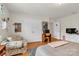 Bright bedroom with laminate flooring, filled with natural light, featuring a beige bed and a cushioned arm chair at 1112 Wagner Ave # 335, Fort Mill, SC 29715