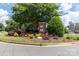 Neighborhood entrance sign amongst a colorful flower bed, mature trees, and manicured bushes at 1112 Wagner Ave # 335, Fort Mill, SC 29715