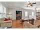 Cozy living room showcasing a fireplace, TV, and plush furniture under a ceiling fan at 1112 Wagner Ave # 335, Fort Mill, SC 29715