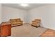 Cozy carpeted living room space with two armchairs and a dark wood cabinet for additional storage at 1112 Wagner Ave # 335, Fort Mill, SC 29715