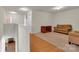 Spacious room featuring carpet, a cozy couch, armchair, and a wooden cabinet, complemented by hardwood flooring at 1112 Wagner Ave # 335, Fort Mill, SC 29715