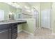 Modern bathroom with dual sink vanity, granite countertop, and glass-enclosed shower stall at 1116 Arnott Ln, Matthews, NC 28105