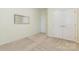Spacious bedroom features neutral carpet, double doors and a mirror on the wall at 1116 Arnott Ln, Matthews, NC 28105