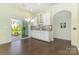 Dining area featuring hardwood floors, stylish lighting, and sliding glass doors to the backyard at 1116 Arnott Ln, Matthews, NC 28105