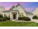 Charming single-story home featuring a well-manicured lawn, inviting entrance, and attached garage at 1116 Arnott Ln, Matthews, NC 28105