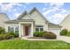Charming single-story home featuring a well-manicured lawn, inviting entrance, and attached garage at 1116 Arnott Ln, Matthews, NC 28105