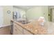 Bright kitchen boasts granite countertops, stainless steel appliances, and a large island at 1116 Arnott Ln, Matthews, NC 28105
