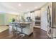 Bright kitchen featuring granite countertops, a kitchen island with bar seating, and stainless steel appliances at 1116 Arnott Ln, Matthews, NC 28105