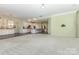 Open-concept living area with plush carpet flowing into a kitchen, and a bright, airy atmosphere at 1116 Arnott Ln, Matthews, NC 28105
