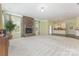 Spacious living room featuring a stone fireplace, plush carpeting, and an open layout to the kitchen at 1116 Arnott Ln, Matthews, NC 28105