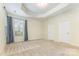 Spacious main bedroom with neutral carpet, recessed ceiling and window with blue curtains at 1116 Arnott Ln, Matthews, NC 28105