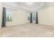 Large main bedroom featuring neutral carpet, recessed ceiling, and natural light from two windows at 1116 Arnott Ln, Matthews, NC 28105