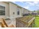 Outdoor patio area features a dining table, wooden planters, and view of the yard at 1116 Arnott Ln, Matthews, NC 28105