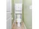 Bright bathroom features a toilet with a cabinet unit for storage and adjacent door at 1116 Arnott Ln, Matthews, NC 28105