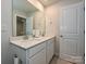 Bright bathroom featuring a double sink vanity with white cabinets and a large mirror at 11807 Midnight Way, Huntersville, NC 28078