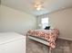 Cozy bedroom with neutral walls, carpet, ceiling fan and a charming white metal bed frame at 11807 Midnight Way, Huntersville, NC 28078