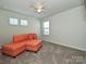 Upstairs room showcasing natural light, carpeted floors, and cozy seating area at 11807 Midnight Way, Huntersville, NC 28078