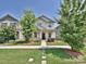 Charming home with a well-manicured front yard and a welcoming entrance flanked by mature trees at 11807 Midnight Way, Huntersville, NC 28078