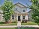 Charming two-story home featuring a blend of siding and brick, with a well-manicured lawn and sidewalk at 11807 Midnight Way, Huntersville, NC 28078
